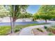View of the garages surrounded by lush landscaping at 3985 W 104Th Dr # E, Westminster, CO 80031