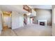 Open-concept living room with a fireplace, chandelier, and staircase at 3985 W 104Th Dr # E, Westminster, CO 80031