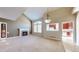 Cozy living room featuring fireplace, arched window, and view into kitchen at 3985 W 104Th Dr # E, Westminster, CO 80031