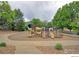 Neighborhood playground with slides and climbing features surrounded by trees and concrete sidewalk at 3985 W 104Th Dr # E, Westminster, CO 80031