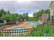 Community pool with chairs for relaxing and enjoying the sunshine surrounded by beautiful green foliage at 3985 W 104Th Dr # E, Westminster, CO 80031