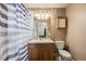 Full bathroom featuring vanity, mirror, lighting, medicine cabinet and a shower with stylish striped curtain at 17282 E Tennessee Dr, Aurora, CO 80017