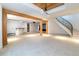 Finished basement offers an open floor plan, bar, and staircase with metal railings and wood treads at 2646 S Madison St, Denver, CO 80210