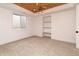 Bedroom with wood beam ceiling detail, built in shelves, and a modern light fixture at 2646 S Madison St, Denver, CO 80210