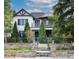 Beautiful two-story home with a stone and wrought iron fence and manicured landscaping at 2646 S Madison St, Denver, CO 80210