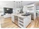 Open concept kitchen with granite counters and stainless steel appliances opens to the living room with fireplace at 2646 S Madison St, Denver, CO 80210