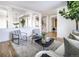 Open-concept living room featuring hardwood floors, modern furnishings, and abundant natural light at 2646 S Madison St, Denver, CO 80210