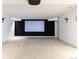 Home media room with large screen and sconce lighting offers the perfect space for movie nights at 2646 S Madison St, Denver, CO 80210