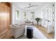 Home office space with French doors, light walls, neutral decor, and a glass desk at 2646 S Madison St, Denver, CO 80210