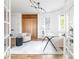 Bright home office space with French doors, a modern light fixture, and neutral decor at 2646 S Madison St, Denver, CO 80210