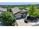 Aerial shot of home showing landscaping, driveway, and beautiful green lawn and neighborhood at 15088 Verbena St, Thornton, CO 80602