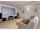 Basement entertainment area with projector screen and comfortable seating at 15088 Verbena St, Thornton, CO 80602