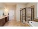 Bathroom features a soaking tub, glass shower and double vanity with plenty of counter space at 15088 Verbena St, Thornton, CO 80602