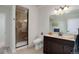 Bathroom featuring tiled shower, vanity with dark wood cabinets, and tiled floors at 15088 Verbena St, Thornton, CO 80602