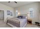 Bright bedroom featuring a brass bed frame, neutral walls, and natural light from two windows at 15088 Verbena St, Thornton, CO 80602