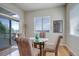 Sunlit breakfast nook features sliding glass doors leading to an outdoor deck at 15088 Verbena St, Thornton, CO 80602