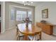 Traditional dining room featuring a wood table, chairs, buffet, and bay windows at 15088 Verbena St, Thornton, CO 80602
