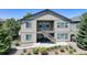 Exterior elevation of this two-story home with a balcony and backyard patio at 15088 Verbena St, Thornton, CO 80602