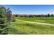 Expansive green golf course surrounded by residential homes and blue skies at 15088 Verbena St, Thornton, CO 80602