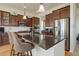 Kitchen island with granite countertops, stainless appliances and pendant lighting at 15088 Verbena St, Thornton, CO 80602