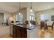 Kitchen with island, stainless steel appliances, and an adjacent eating area with abundant natural light at 15088 Verbena St, Thornton, CO 80602