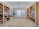 Spacious library featuring built-in bookshelves and a window seat at 15088 Verbena St, Thornton, CO 80602
