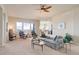 Bright living room with neutral tones and an open layout flowing into the kitchen at 15088 Verbena St, Thornton, CO 80602