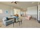 Comfortable living room features neutral walls, carpeted floors, and glass coffee table with seating at 15088 Verbena St, Thornton, CO 80602