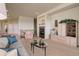 Comfortable living room featuring a fireplace and an open floor plan at 15088 Verbena St, Thornton, CO 80602