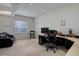 Bright home office with large window and modern desk setup at 15088 Verbena St, Thornton, CO 80602