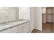 Bright bathroom features double sinks, granite counters, a shower, and closet at 5385 Trails Edge Ln, Castle Rock, CO 80104