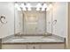 Bright bathroom features double sinks, granite counters, a shower, and modern lighting at 5385 Trails Edge Ln, Castle Rock, CO 80104