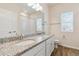 Bright bathroom features double sinks, granite counters, a shower, and natural light at 5385 Trails Edge Ln, Castle Rock, CO 80104