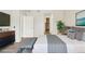 This staged bedroom features neutral tones, closet, and decor for a relaxing atmosphere at 5385 Trails Edge Ln, Castle Rock, CO 80104