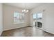 Bright dining room with wood-look floors, modern lighting, and outdoor access at 5385 Trails Edge Ln, Castle Rock, CO 80104