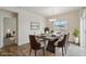 Staged dining room with modern table, chairs, chandelier, and view from the window at 5385 Trails Edge Ln, Castle Rock, CO 80104