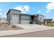 Charming home with a gray exterior, well-manicured lawn, a stone facade, and a spacious driveway at 5385 Trails Edge Ln, Castle Rock, CO 80104