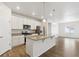 Bright kitchen featuring an island, stainless appliances, granite counters and sight lines to the living area at 5385 Trails Edge Ln, Castle Rock, CO 80104