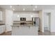 Bright kitchen featuring white cabinets, stainless steel appliances, granite counters, and a large island at 5385 Trails Edge Ln, Castle Rock, CO 80104