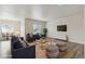 Open-concept living room featuring modern furniture, a TV, and wood-look flooring at 5385 Trails Edge Ln, Castle Rock, CO 80104
