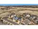 A high aerial view shows single Gathering homes with a brown open space and hills in the background at 7378 Geode Ct, Castle Rock, CO 80108