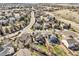 Aerial view of a neighborhood with mature trees, green lawns and single Gathering homes on a clear day at 7378 Geode Ct, Castle Rock, CO 80108