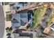 A high aerial view shows a backyard with a hot tub, deck and privacy fence with some mature trees at 7378 Geode Ct, Castle Rock, CO 80108