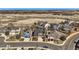 An aerial view of the neighborhood with a field in the background of single Gathering homes at 7378 Geode Ct, Castle Rock, CO 80108
