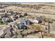 A high aerial view shows single Gathering homes with a brown open space and hills in the background at 7378 Geode Ct, Castle Rock, CO 80108