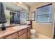 Cozy bathroom featuring a sleek vanity, framed mirror, and a toilet at 7378 Geode Ct, Castle Rock, CO 80108
