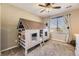 Playful bedroom featuring a unique house-shaped bed frame and ample natural light at 7378 Geode Ct, Castle Rock, CO 80108