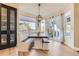 Bright dining area with bench seating, a modern chandelier, and large windows for natural light at 7378 Geode Ct, Castle Rock, CO 80108
