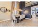 Elegant dining room featuring high ceilings, modern lighting, and a stylish dining table with seating at 7378 Geode Ct, Castle Rock, CO 80108