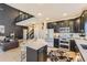 Well-designed kitchen featuring an island with seating and modern appliances flowing into living area at 7378 Geode Ct, Castle Rock, CO 80108